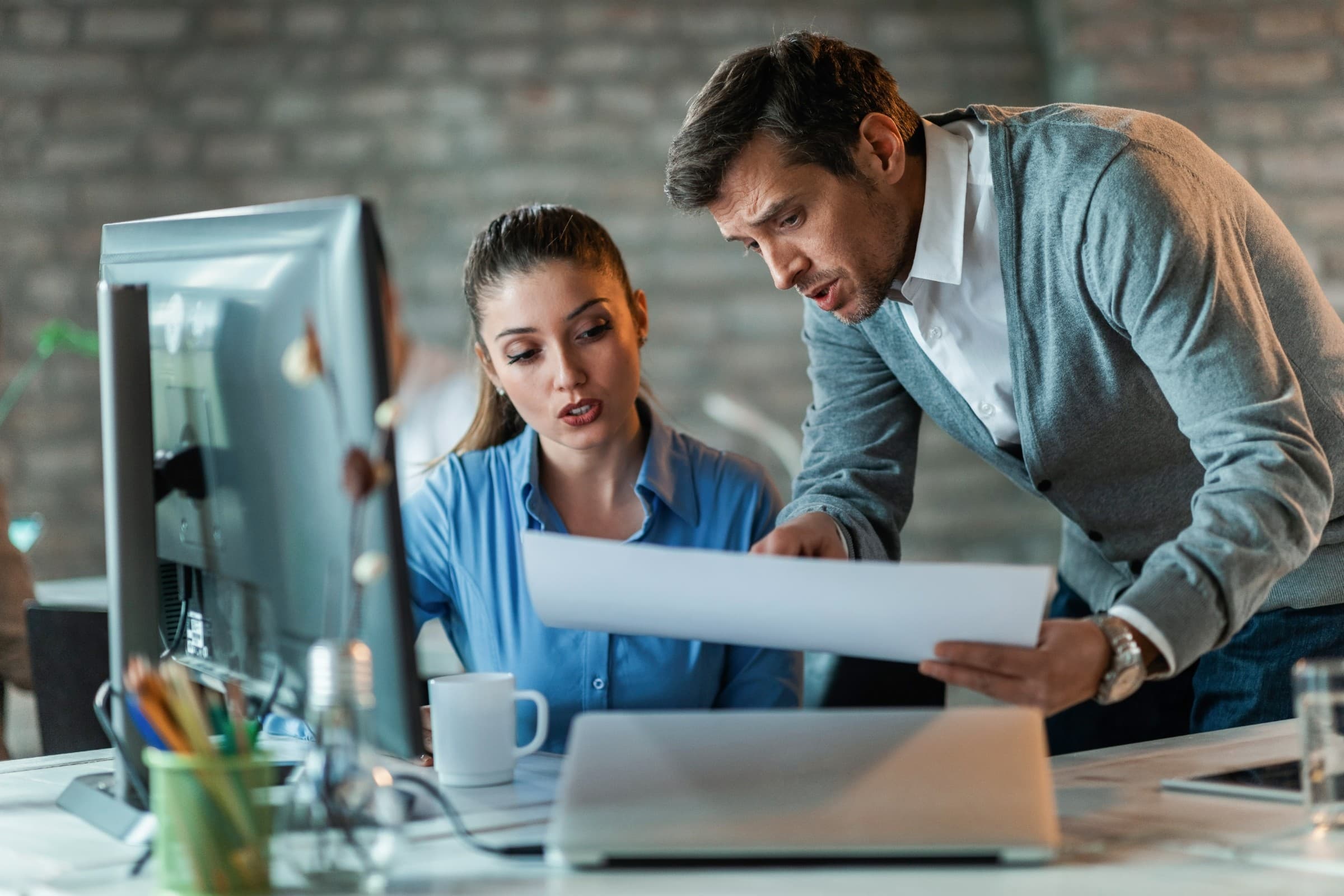 Two colleagues going through a document together